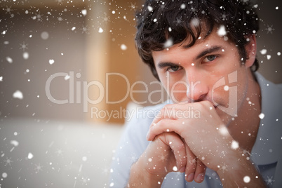 Composite image of man in the living room in thoughts