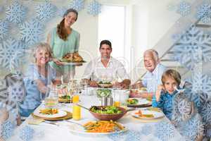 Composite image of family having meal at dining table