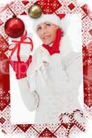 Composite image of festive woman listening and holding gift