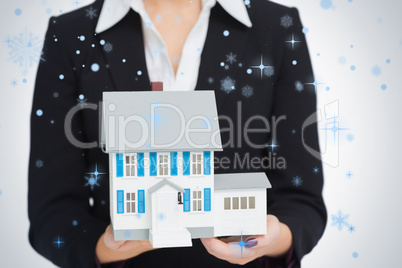 Real estate agent holding a model house