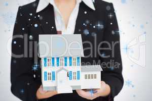 Real estate agent holding a model house