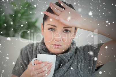 Composite image of ill woman sitting on the couch in a living ro