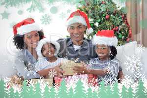 Composite image of smiling family sharing christmas presents