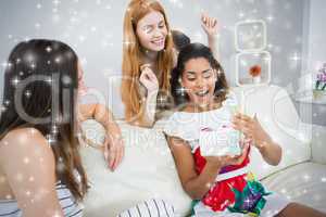 Composite image of cheerful young women surprising friend with a