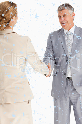 Composite image of happy business people shaking hands