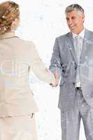 Composite image of happy business people shaking hands