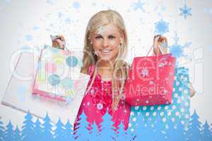 Smiling blonde showing shopping bags