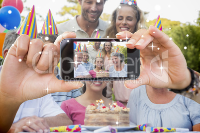 Hand holding smartphone showing photo