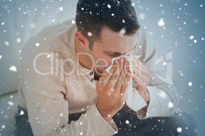 Composite image of ill man blowing his nose