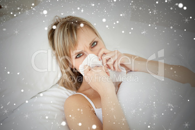 Composite image of sick blonde woman blowing lying on her bed