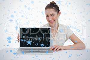 Smiling businesswoman showing a laptop