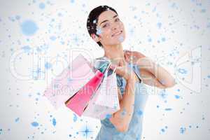 Darkhaired woman posing with shopping bags