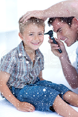 Composite image of doctor checking a patients ears