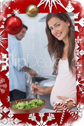 Pregnant woman preparing a salad in the kitchen