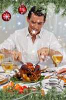 Composite image of attractive man eating turkey in christmas din