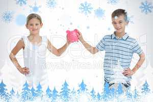 Brother and sister holding piggy bank together