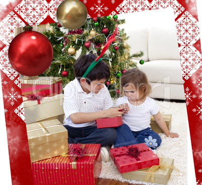 Happy brother and sister looking at christmas gifts