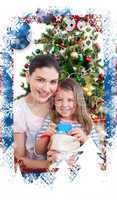 Composite image of mother and daughter at home at christmas time