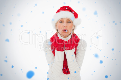 Composite image of festive woman blowing a kiss