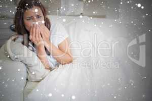 Composite image of woman with a cold lying on sofa