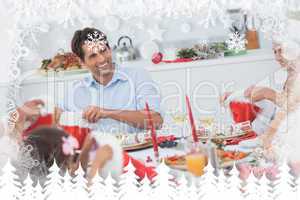 Composite image of cheerful family dining together