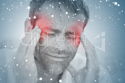 Composite image of man having a headache