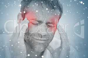 Composite image of man having a headache