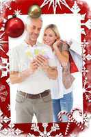 Happy couple holding shopping bags and cash