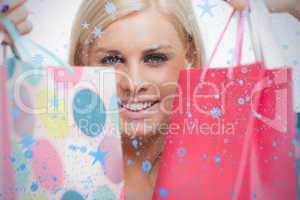 Smiling blonde showing her shopping bags