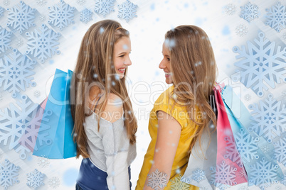 Rear view of two young women with shopping bags