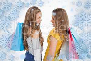 Rear view of two young women with shopping bags