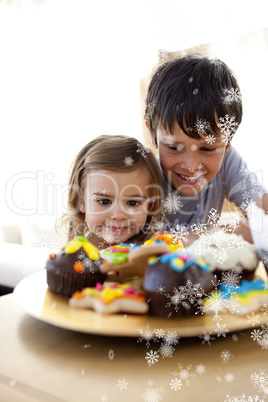 Composite image of brother and sister looking at confectionery