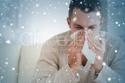 Composite image of tired man blowing his nose