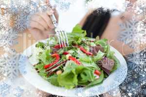 Composite image of close up of a woman eating a salad