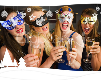 Attractive friends with masks on holding champagne glasses
