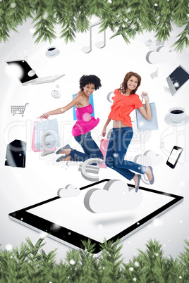 Composite image of two smiling women jumping on a tablet pc