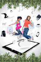 Composite image of two smiling women jumping on a tablet pc