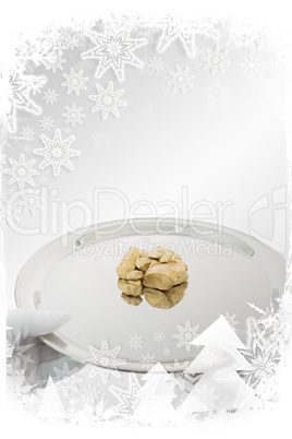 Composite image of man holding gold nuggets on a silver tray