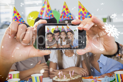 Hand holding smartphone showing photo