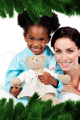 Smiling little girl with her nurse looking at the camera