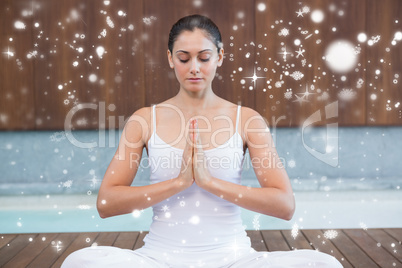 Peaceful woman in white sitting in lotus pose