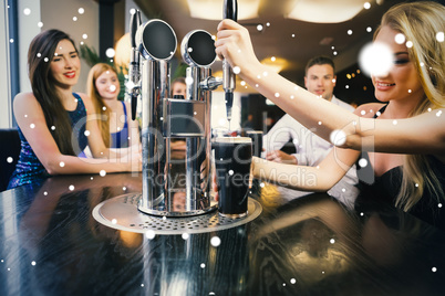 Composite image of blonde woman pulling a pint of stout