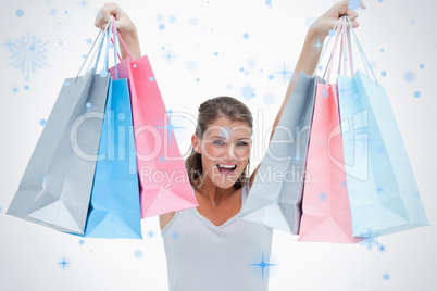 Cheerful woman holding shopping bags