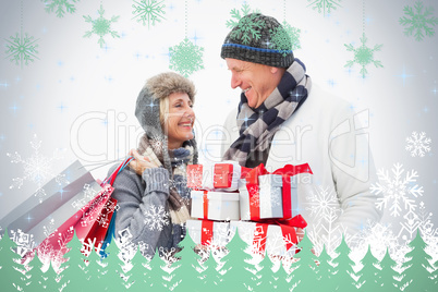 Mature couple in winter clothes holding gifts