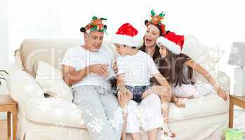 Composite image of family on christmas day looking at their pres