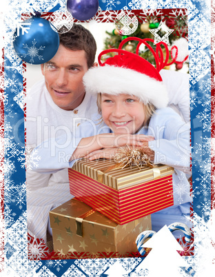 Composite image of smiling father and his son holding christmas