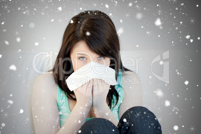 Composite image of portrait of a sick attractive woman blowing