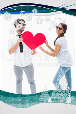Composite image of hipster couple smiling at camera holding a he
