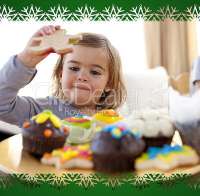 Happy little girl eating confectionery at home