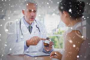 Composite image of doctor explaining the pills to patient